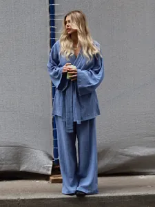 Close-up detail of a blue crinkle cotton long-sleeved pajama set featuring a tie-waist