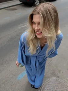 Close-up of blue cotton wrap pajama set with belt detail in a street setting