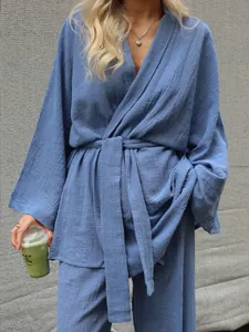 Close-up of blue textured cotton long-sleeve pajama set showing fabric detail and waist tie