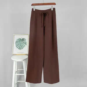 Detailed view of brown knitted wide-leg pants with elastic drawstring waist.