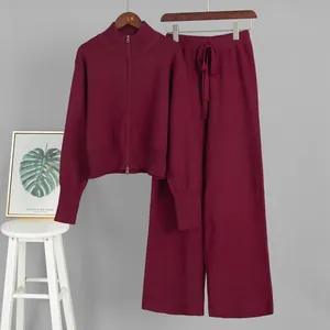 Detail view of wine red two-piece knitted set with zip-up sweater and wide-leg trousers