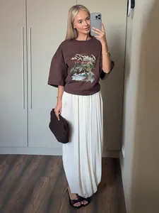 Vue détaillée de la jupe longue tulipe blanche plissée avec un t-shirt décontracté