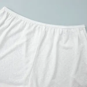 Close-up of white semi-transparent fabric detail with elastic waistband for beach set
