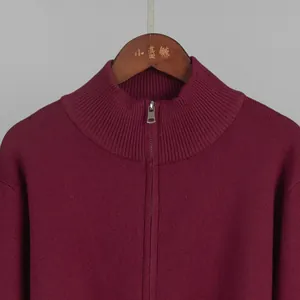 Close-up detail of burgundy knit sweater with silver metal zipper neckline