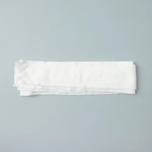 Detailed view of white semi-transparent fabric sash from three-piece beachwear set