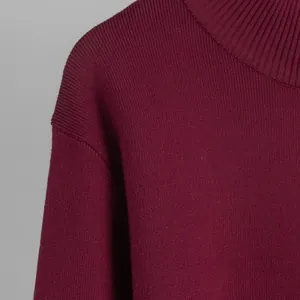 Close-up detail of burgundy mock neck knitted sweater showing high-quality ribbing texture