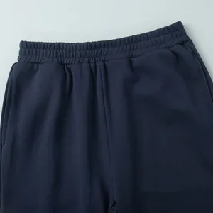 Detailed view of the elastic waistband and soft fabric texture on navy blue sweatpants.