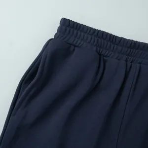 Detail view of elastic waistband and side pocket on navy casual joggers