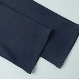 Macro view of double-stitched hem detail on navy blue casual leisure sweatpants