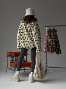 Back view of a cozy white fleece hoodie with delicate floral print for winter fashion