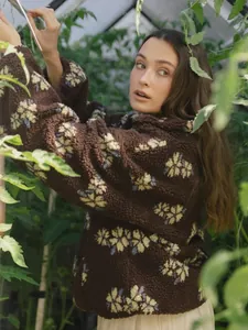 Detailed close-up of a brown floral sherpa fleece sweatshirt for women in autumn.