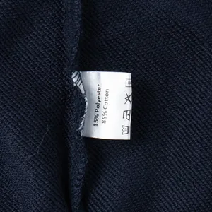 Close-up of wash care label showing 85% cotton and 15% polyester material composition