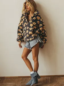 Detailed view of a model wearing a floral fleece sweatshirt with soft texture detail