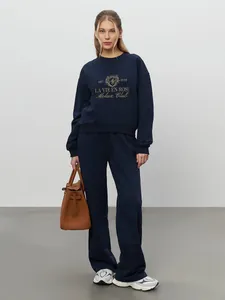 Full body view of navy blue embroidered sweatshirt and sweatpants casual set for women.