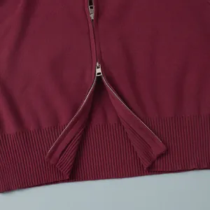 Detail view of burgundy knitted sweater with high-quality metal double zipper