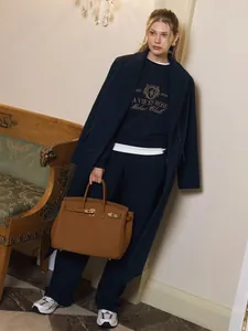 Navy embroidered sweatshirt and pants set styled with a classic long coat
