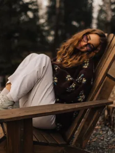 Cozy brown floral fleece sweatshirt for women shown in a relaxed outdoor lifestyle setting