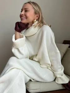 Detailed view of a cozy white turtleneck sweater and matching knit pants for winter.
