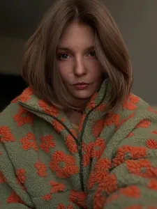 Detailed close-up view of a green and orange floral sherpa fleece zip-up sweatshirt.