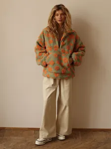 Cozy green fleece sweatshirt with orange floral patterns, quarter zip collar and pocket