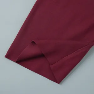 Close-up detail of the ribbed knit hem on a burgundy slim sweater set for women