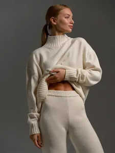 Detail view of cream ribbed knit sweater set showing soft texture and mock neck design