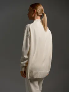 Back view of a chic cream half-turtleneck knitted sweater and matching pants set.