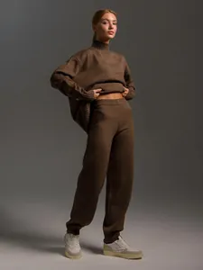 Full view of women's brown turtleneck knit sweater and matching pants set