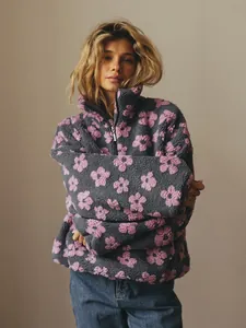 Cozy grey fleece sweatshirt with pink floral patterns, styled for a warm winter look