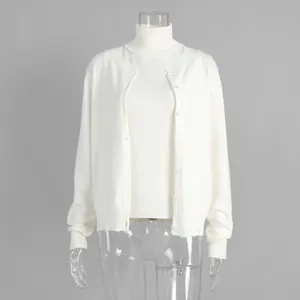 Front view of elegant white knitwear set with turtleneck sleeveless top and cardigan