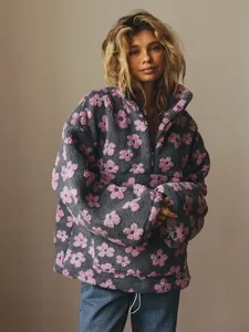 Detailed view of women's gray and pink floral pattern polar fleece half-zip sweatshirt.