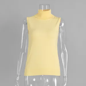Close-up detail view of a pale yellow knitted sleeveless turtleneck vest on a mannequin