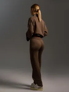 Back view of a cozy brown knit set featuring a mock neck sweater and matching pants