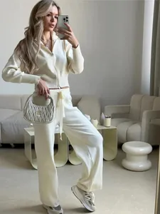Elegant cream knitted two-piece set featuring zip-up cardigan and matching wide-leg trousers