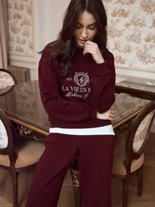 Detail of burgundy embroidered sweatshirt and sweatpants casual two-piece lounge set