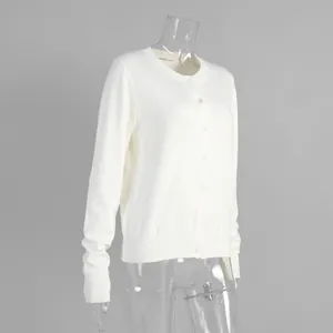 Detailed view of cream knit cardigan with button-up front and ribbed cuffs on a mannequin