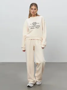 Full shot of a two-piece casual loungewear set with sweatshirt and joggers in cream white color