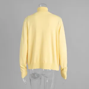 Back view of a yellow turtleneck knit sweater on a transparent torso mannequin