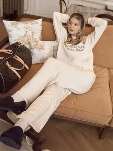 Close-up detail of a cream cream-colored embroidered sweatshirt and sweatpants loungewear set