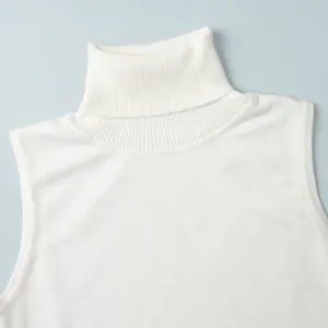 Close-up view of white turtleneck sleeveless knit vest showing fine ribbing textures.