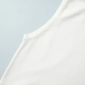 Macro view showing the fine texture and stitching of a white knitted sleeveless vest top