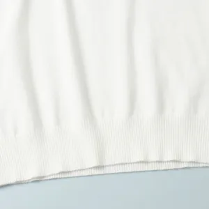 Detailed view showing the high-quality ribbed hem of a white knitted sleeveless top