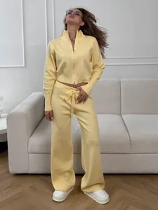 Detailed view of pale yellow knit two-piece lounge set with zip-up sweater and wide-leg trousers