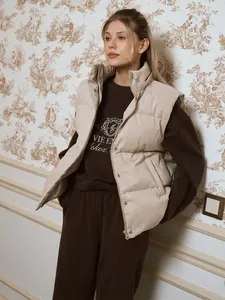 Detail view of women's autumn tracksuit with brown embroidered sweatshirt and vest