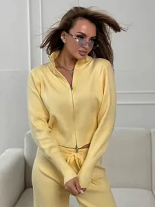 Close-up of a stylish yellow two-piece knitted sweater set featuring a double zip-up jacket