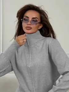 Close-up of grey slim-fit knitted sweater featuring a stand collar and front zip closure