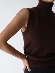 Detailed view of a minimalist brown sleeveless turtleneck knit vest with soft texture.