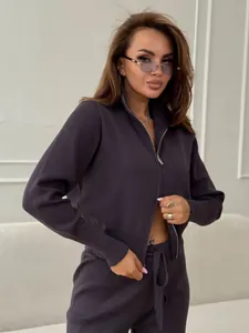 Detailed view of a stylish grey knitted two-piece set with a double zip-up cardigan.