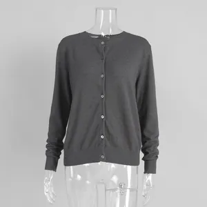 Detail view of a dark grey button-up knitted cardigan on a clear mannequin.
