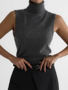 Detail view of a grey high collar sleeveless knitted vest for women's autumn style